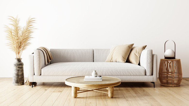 A sleek gray couch with just one seat cushion