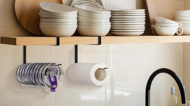 Jolensoy Tumbler Lid Organizer being used to hold lids and paper towels in kitchen