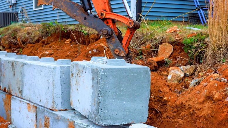 Concrete retaining wall being built in residential area