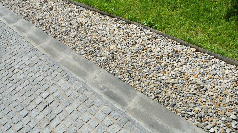 A French drain installed alongside a driveway to prevent flooding
