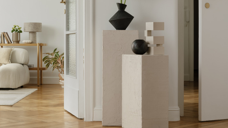 Modern display plinths with artistic vases and art objects on top