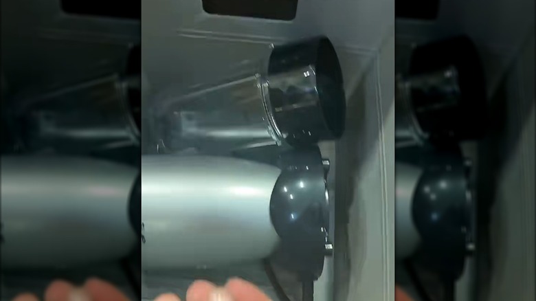 A small blender stored in its own plastic locker bin