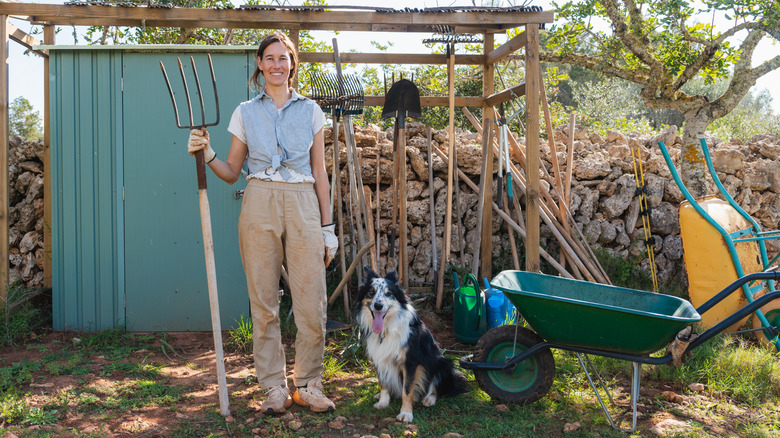 A happy woman with garden tools