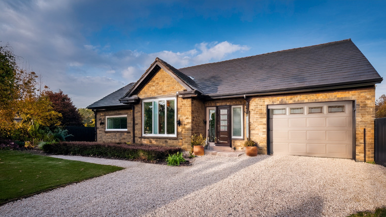 Home with gravel driveway.