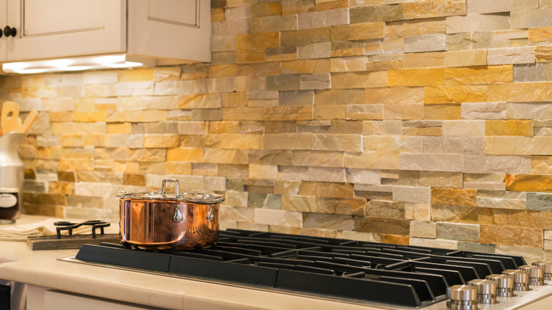 Stone backsplash behind a stove