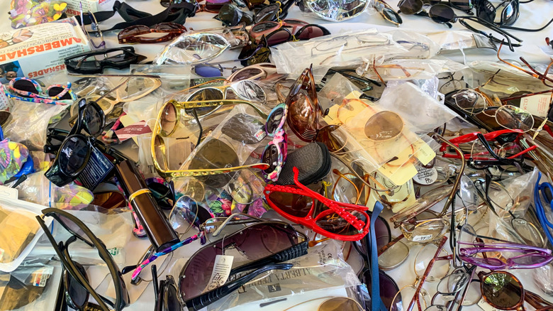 A cluttered pile of sunglasses