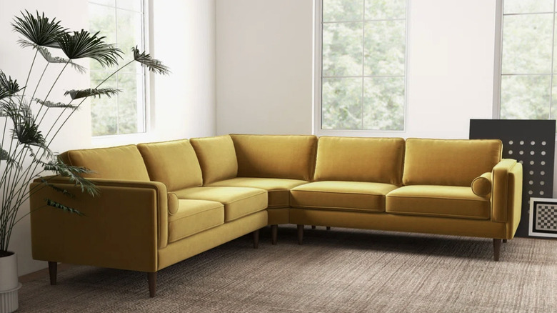 Ochre yellow sectional couch in living room