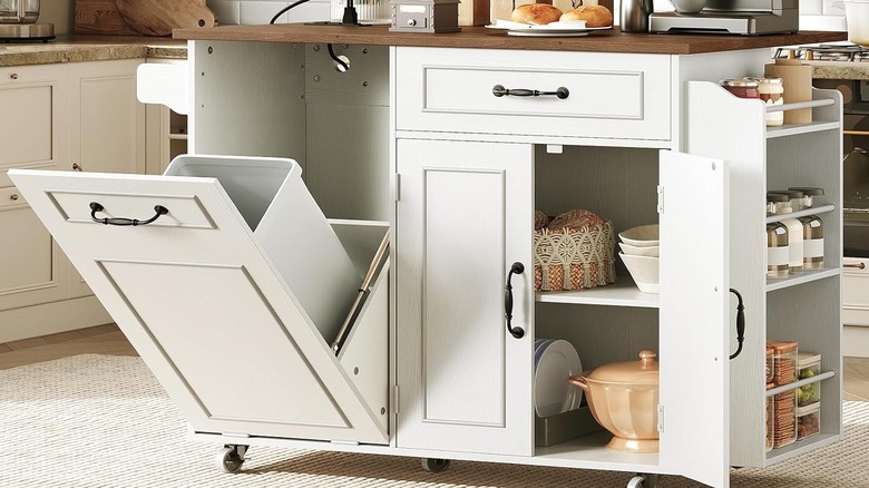 White rolling kitchen cart with wood-tone top and a tilt-out garbage can compartment, along with other storage