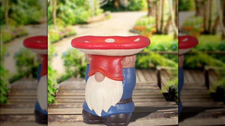 The Style Selections Resin Bird Bath from Lowe's shaped like a gnome holding a mushroom