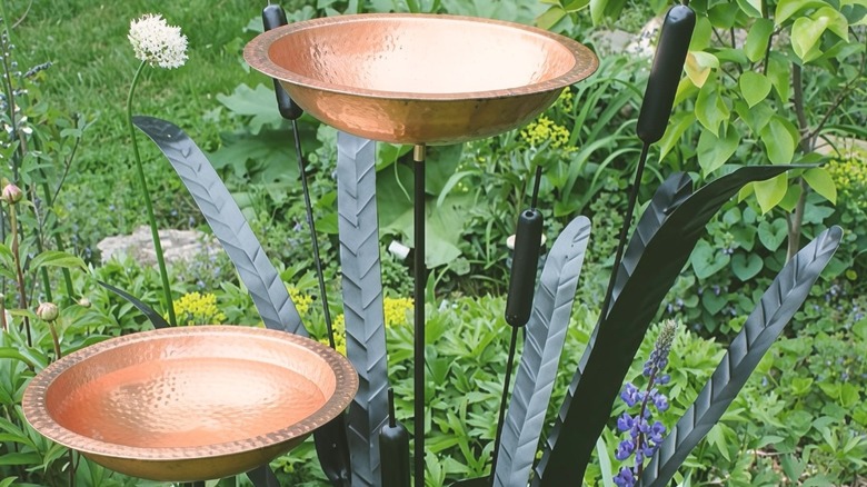 the Minuteman International copper birdbath installed in a garden