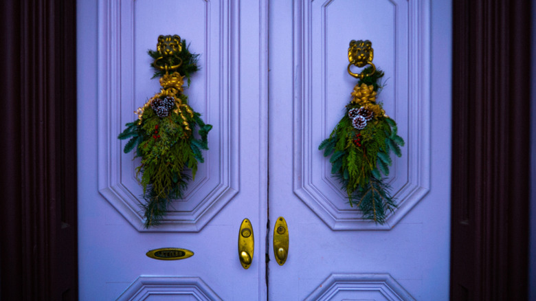 Two door swag arrangements on a purple double door