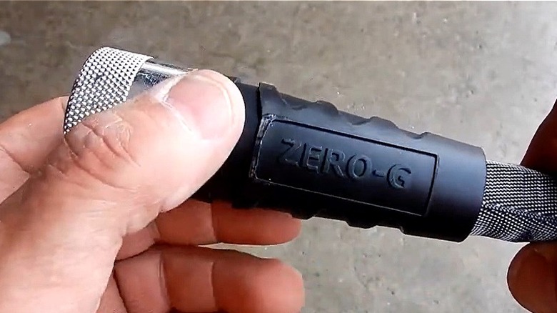 Close-up of a person's hands holding an end of a Zero-G hose