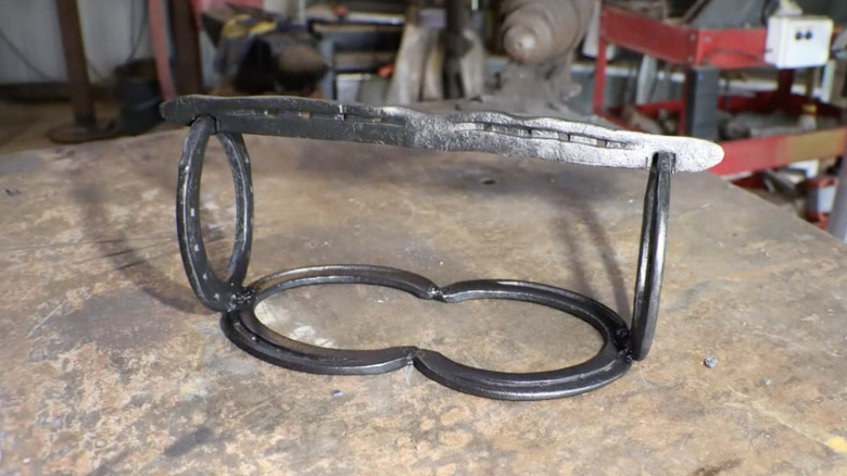 A rustic DIY paper towel holder made from horseshoes