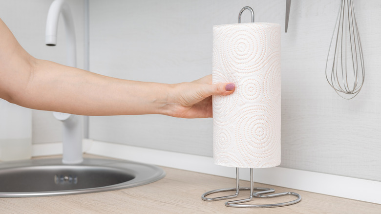A standard paper towel holder on a kitchen worktop