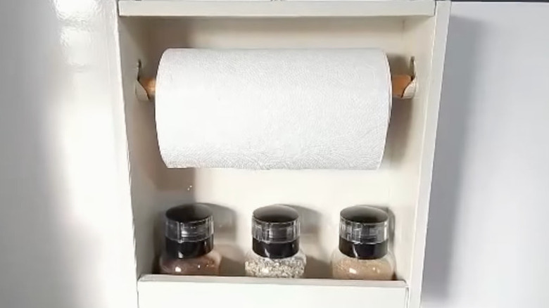A paper towel and spice holder made from an old drawer