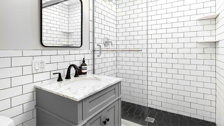 A modern bathroom with white subway tiles