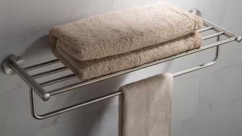 Brass towel bar and shelf in a bathroom setting
