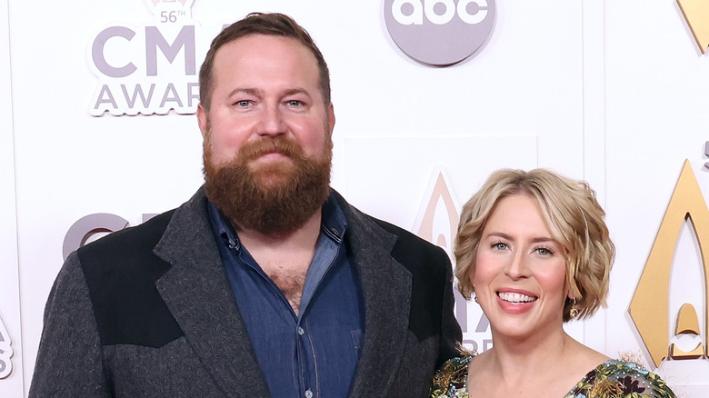 Ben and Erin Napier smiling on a red carpet