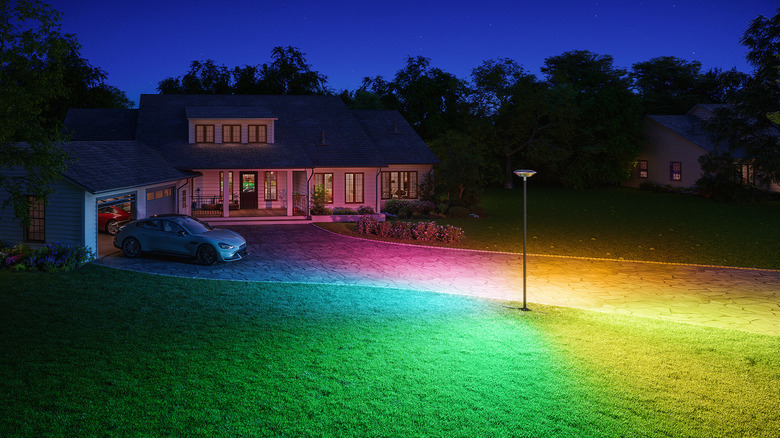 Govee outdoor lamp post light creating a colorful glow in the front yard of  house