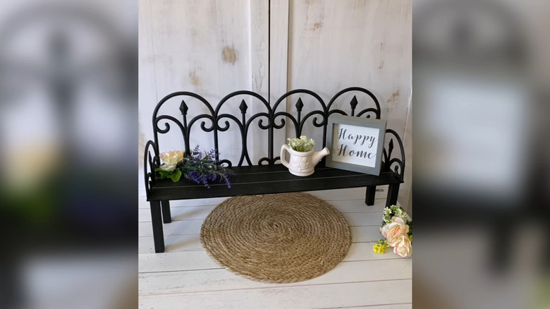 A little DIY bench, painted in black and decorated with small accessories.