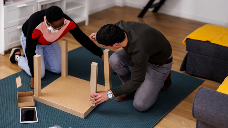 couple building ikea table