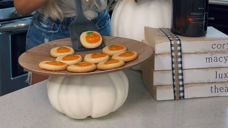 DIY white pumpkin serving tray with cookies on wooden topper