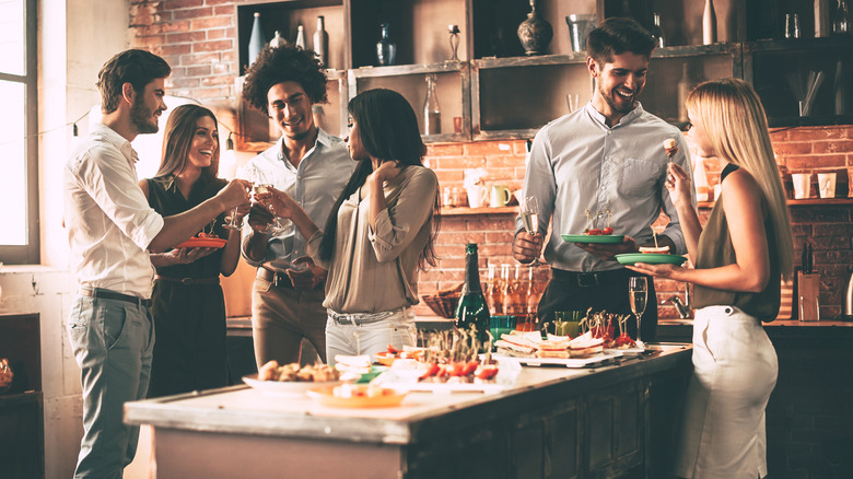 friends stand at a party