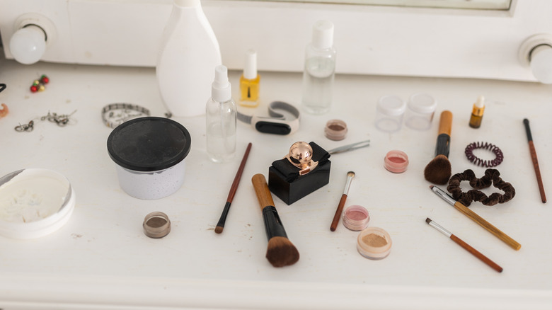 messy vanity with makeup brushes