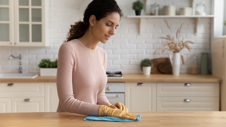 Woman cleaning kitchen