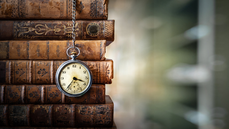 Antique pocket watch and books