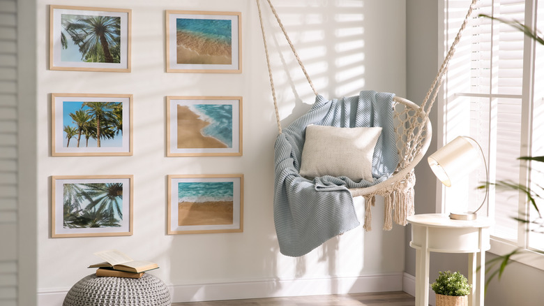 An organized gallery wall arranged in a grid fashion with identical frames and matting