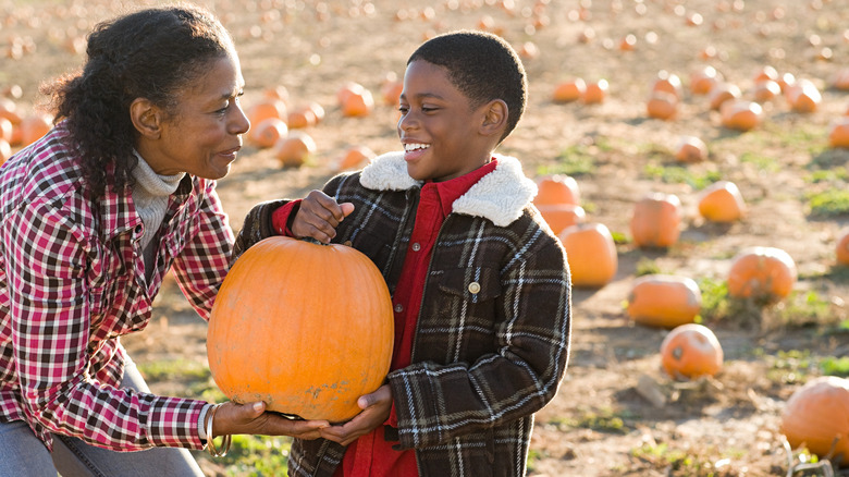 mom and son with pumpkin