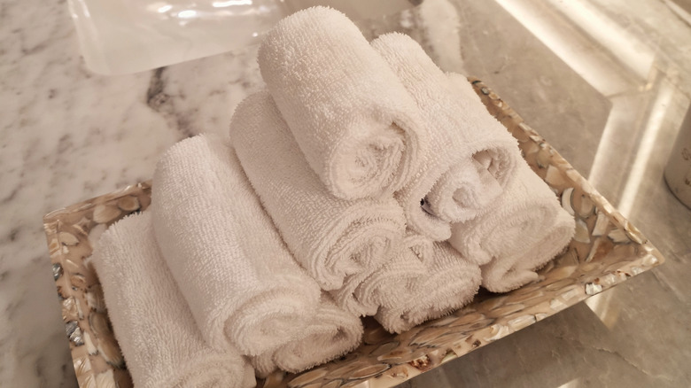Tray of hand towels on bathroom counter