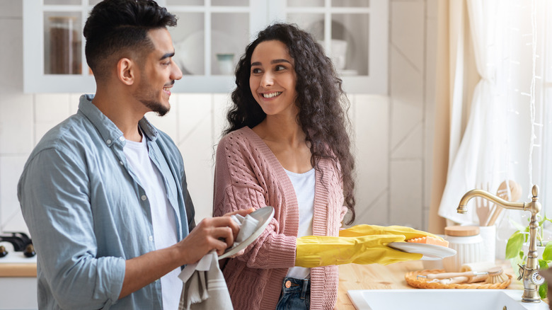 two people washing dishes