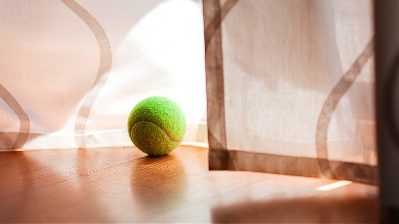 tennis ball near curtains
