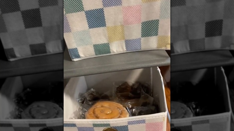 snacks in a bin in a storage shelf