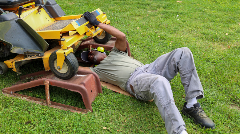 A man repairing a lawn mower