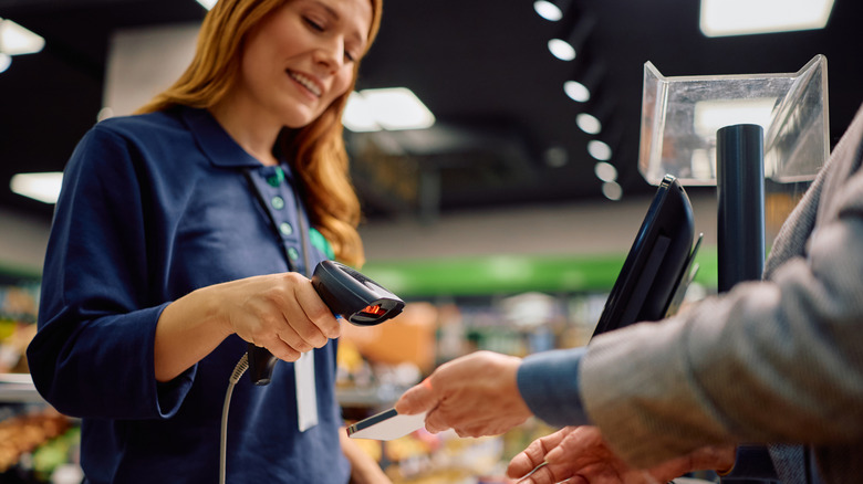 person scanning phone at checkout line