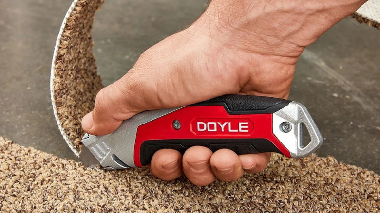 Doyle's Professional Retractable Utility Knife being used to cut carpet