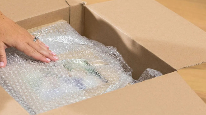 Close-up of a box containing items covered in bubble wrap