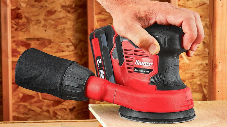 A close-up of Bauer's 20V Cordless 5 in. Random Orbit Sander in use