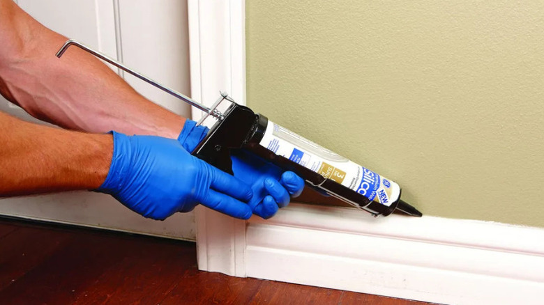 A person using Harbor Freight's 9 inch Caulking Gun