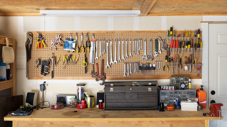 A workspace in a garage with lots of tools