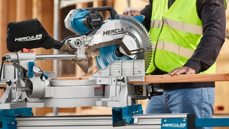 Worker using a Hercules-branded miter saw