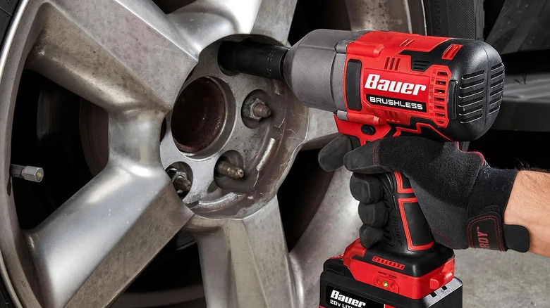Close-up of Bauer's brushless cordless 1/2-inch high-torque impact wrench in use on a car wheel
