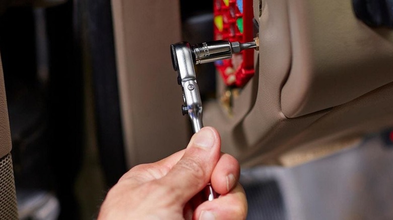 A hand turning an Icon socket wrench