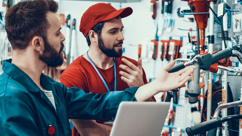 Two men shopping for tools in a hardware store.
