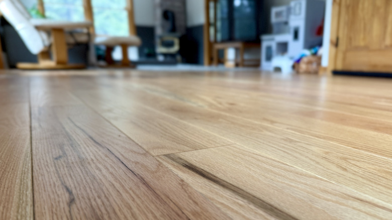 Tight closeup of a hardwood floor against a blurry background