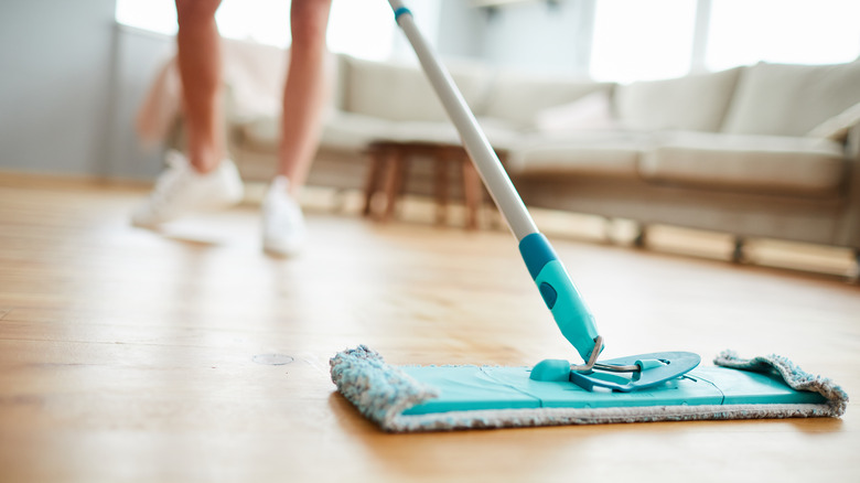 person cleaning floors in house