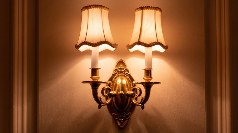 A vintage wall sconce casting the light downward